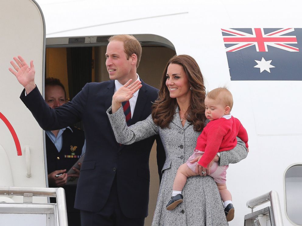 PHOTO: Britains Prince William and Kate, the Duchess of Cambridge, with son Prince George, stand atop of the stairs and wave good bye as they board their flight in Canberra, Australia.