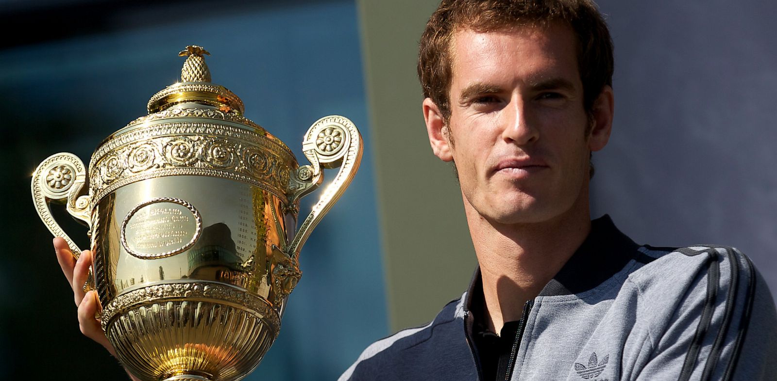 PHOTO: British tennis player Andy Murray poses with the 2013 Wimbledon trophy at the All England Club in Wimbledon, southwest London, on July 8, 2013.