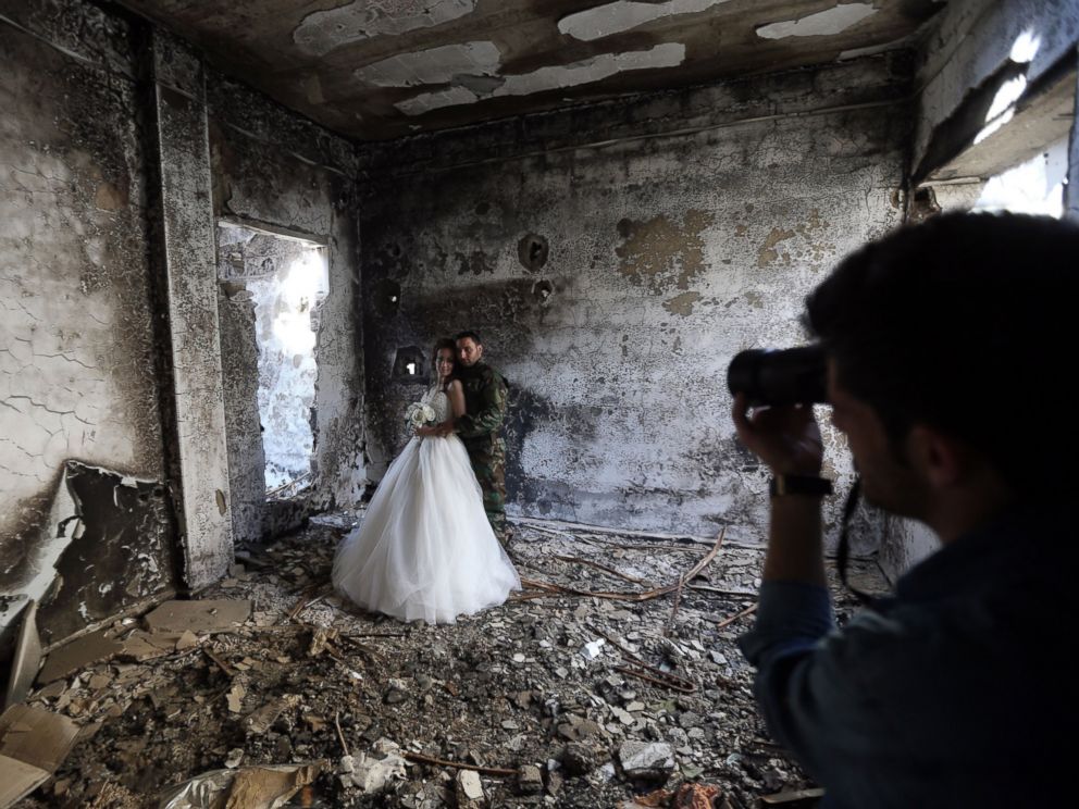 PHOTO: Newly-wed Syrian couple Nada Merhi, and Hassan Youssef, have their wedding pictures taken in a heavily damaged building in the war ravaged city of Homs on Feb. 5, 2016.