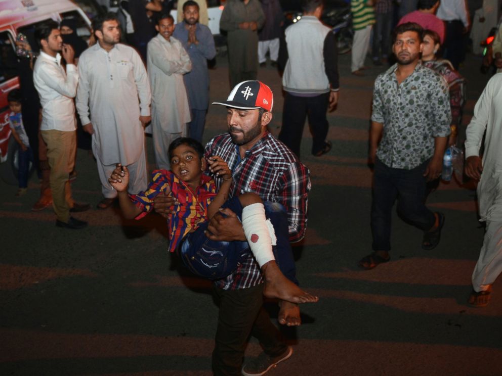 PHOTO: A Pakistani relative carries an injured child to the hospital in Lahore, March 27, 2016, after an apparent suicide bomb ripped through the parking lot of a crowded park in the Pakistani city of Lahore where Christians were celebrating Easter.