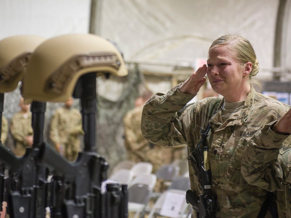 PHOTO: Service members from several units at Bagram Air Field, Afghanistan, pay their respects during a fallen comrade ceremony held in honor of six Airmen, Dec. 23, 2015. 