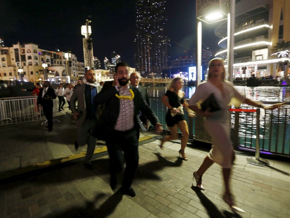 PHOTO: People run away as a fire engulfs The Address Hotel in downtown Dubai in the United Arab Emirates Dec. 31, 2015.