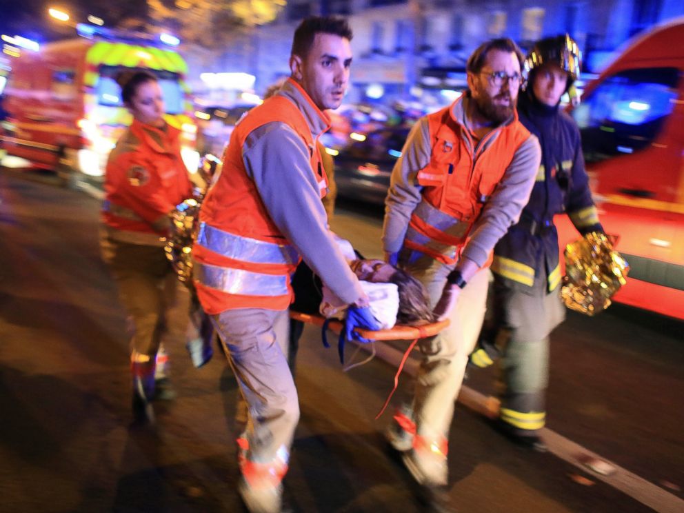 PHOTO: A woman is evacuated from the Bataclan theater after a shooting in Paris, Nov. 13, 2015.