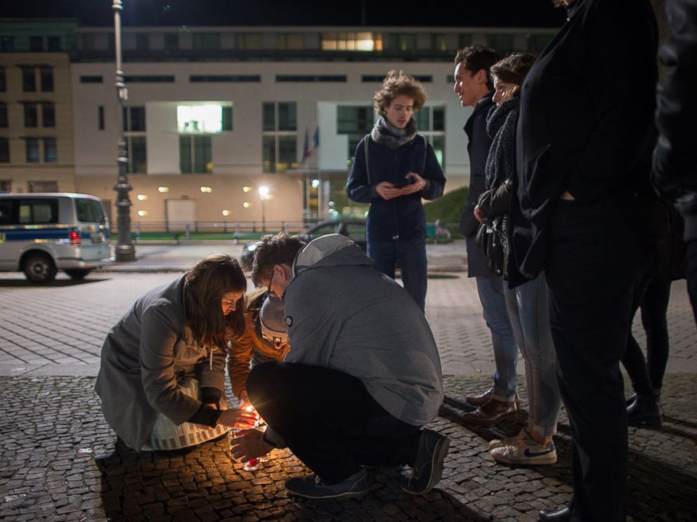 PHOTO: People light candles in tribute to the victims of the Paris attacks outside the French embassy in Berlin on Nov. 13, 2015.