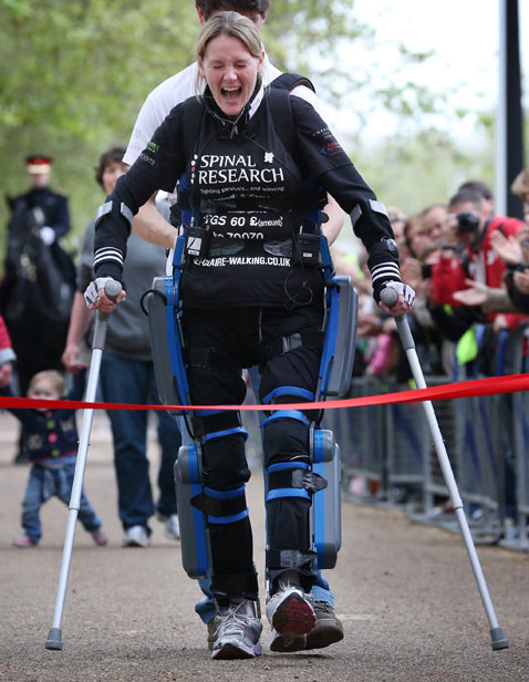 gty paralysed woman finishes marathon ss thg 120508 wblog Today in Pictures: Slave Labor Protests, WWII Re enactment, Buddhas Birthday and Beyonce