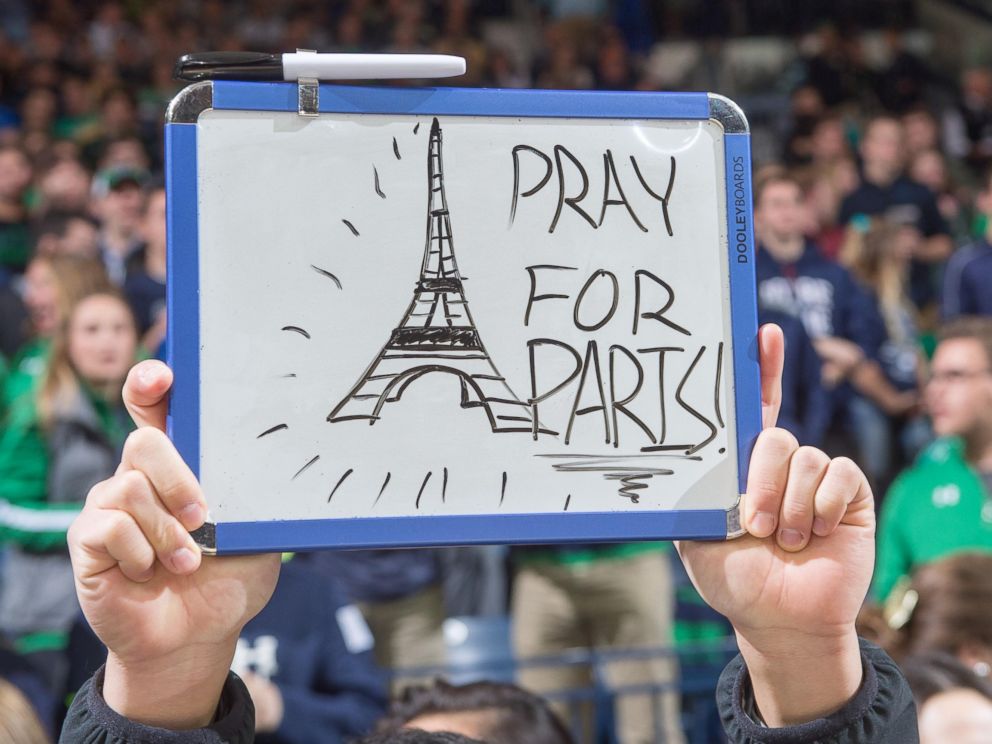 PHOTO: A student holds a sign in recognition of the attacks in Paris before the game between the Notre Dame Fighting Irish and the St. Francis Red Flash at the Purcell Pavilion on Nov. 13, 2015, in South Bend, Ind.