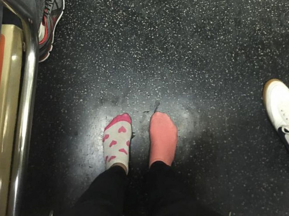 PHOTO: Kay Brown stands on a subway train in her socks, Nov. 16, 2015, after giving her shoes to a homeless woman.