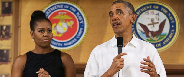PHOTO: First lady Michelle Obama looks on as President Barack Obama speaks during an event to thank service members and their families at Marine Corp Base Hawaii, on Friday, Dec. 25, 2015, in Kaneohe Bay, Hawaii.