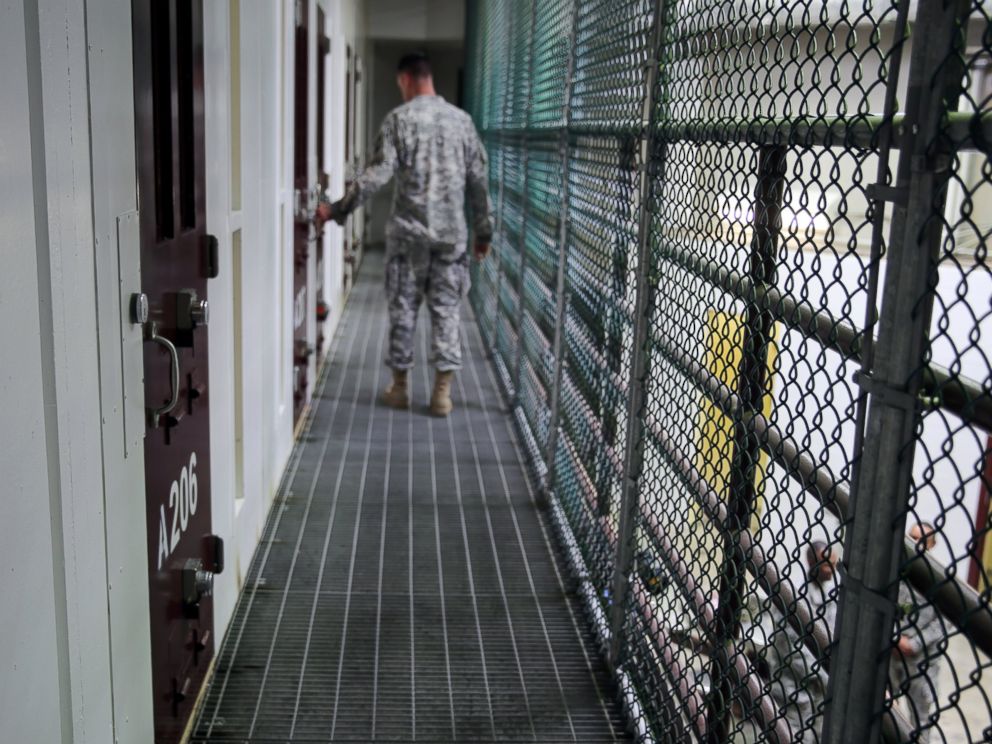 PHOTO: An Army captain walks outside unoccupied detainee cells inside Camp 6 at the U.S. detention center at Guantanamo Bay, Cuba, Feb. 6, 2016. 