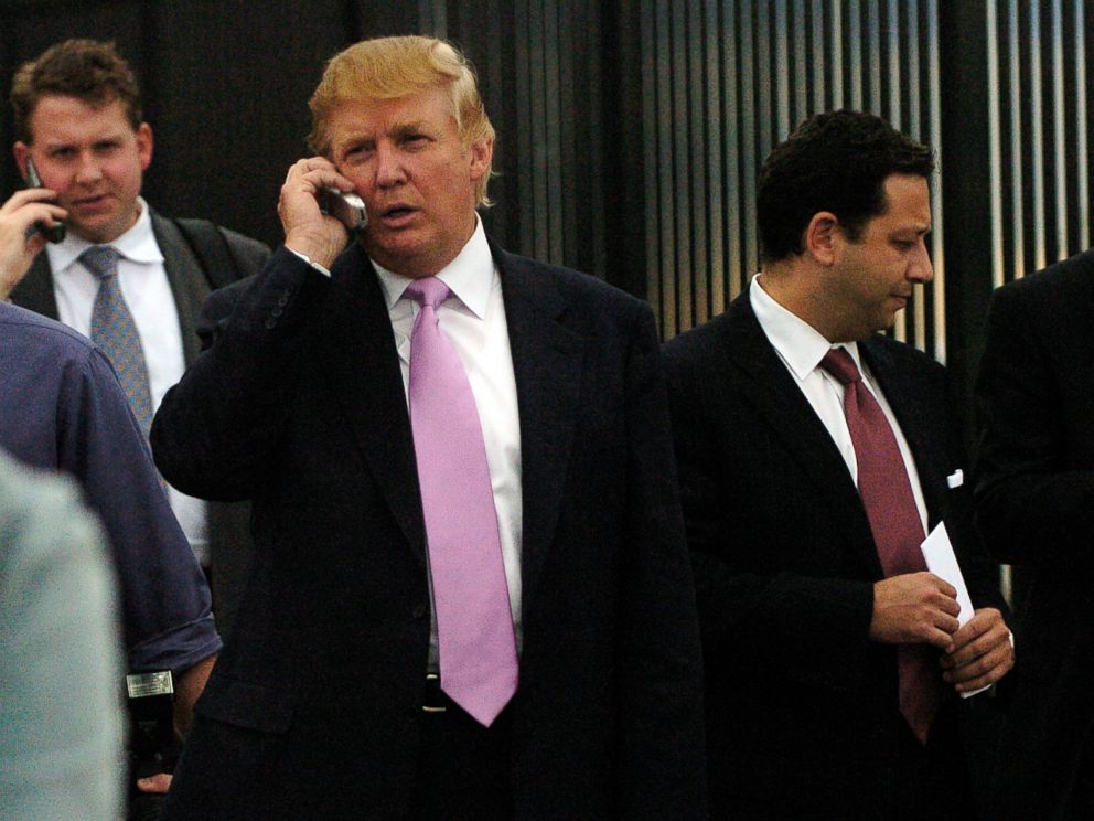 PHOTO: Donald Trump exits the Budweiser Events Center after talking at the Bixpo 2005 convention in Loveland, Colo., Sept. 14, 2005. Felix Sater appears in the red tie on Trumps left.