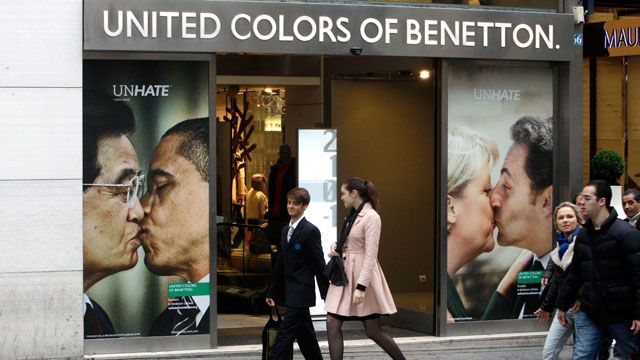 PHOTO People walk past Benetton's Unhate campaign at a shop Nov17 
