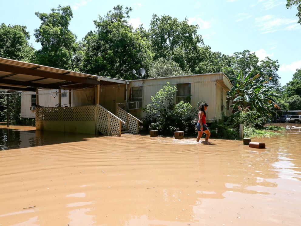 PHOTO:Irene Martinez, who lives near the Brazos River, leaves her flooded home, May 29, 2016, in Richmond, Texas. 