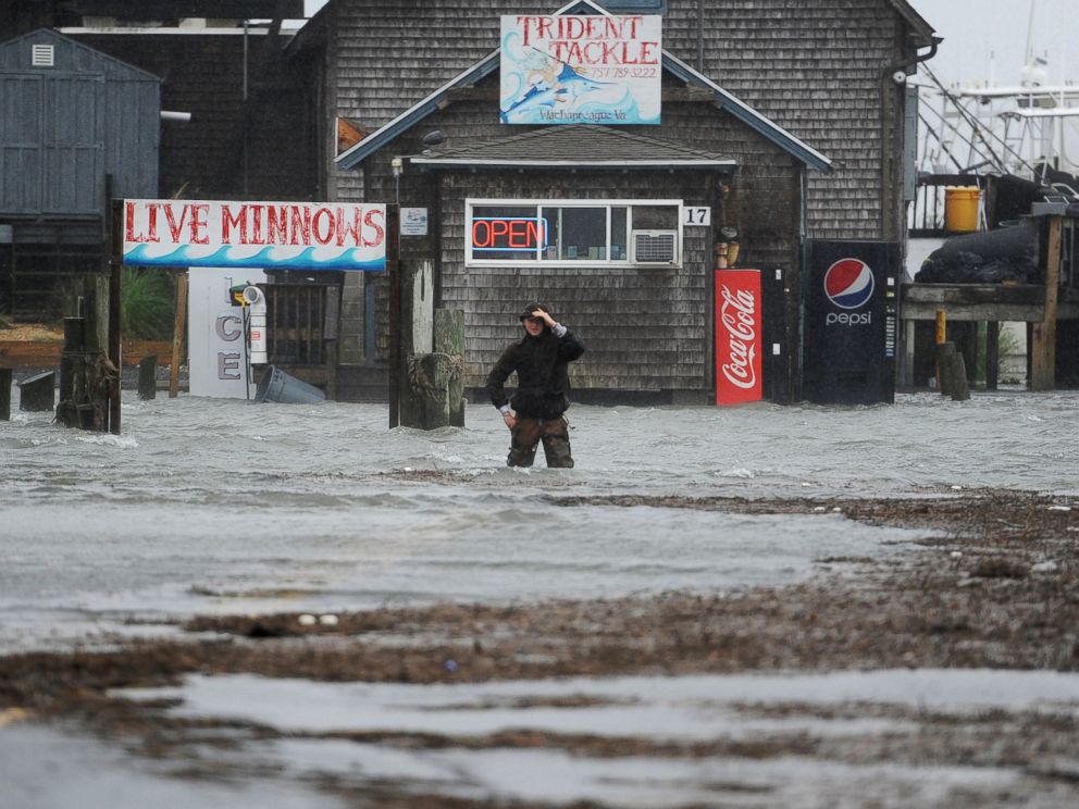 PHOTO: Quinn Hurt looks across Atlantic Avenue as he attempts to cross the flooded street in Wachapreague, Va., Oct. 2, 2015.