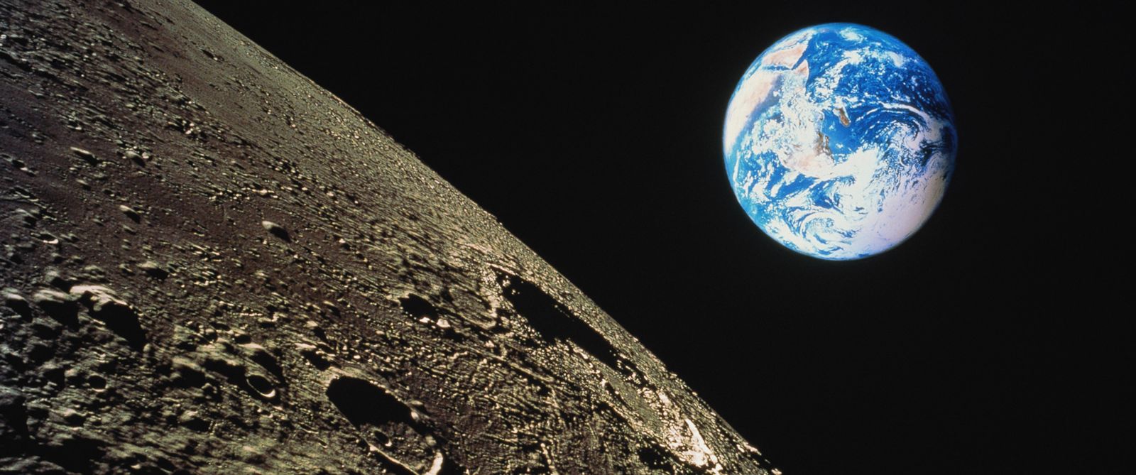 PHOTO: The moons surface is shown with the earth in background in this composite photograph.