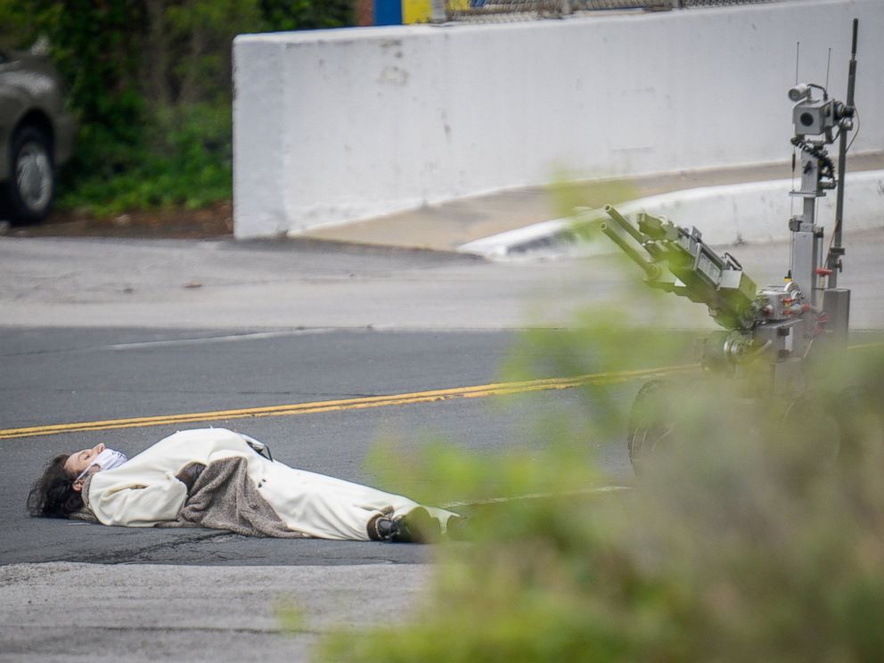 PHOTO: A man, claiming to have a bomb, lays in the street outside of the Fox45 television station, which was evacuated due to a bomb threat, in Baltimore, April 28, 2016. 