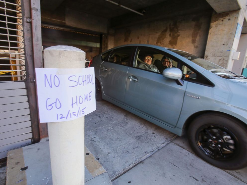 PHOTO: A vehicle leaves the Miguel Contreras Learning Complex past a sign that reads No School Go Home, Dec. 15, 2015, in Los Angeles.