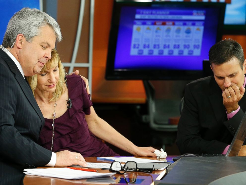 PHOTO:WDBJ-TV7 news morning anchor Kimberly McBroom, center, gets a hug from visiting anchor Steve Grant, left, as meteorologist Leo Hirsbrunner reflects after their early morning newscast at the station, Aug. 27, 2015, in Roanoke, Va.