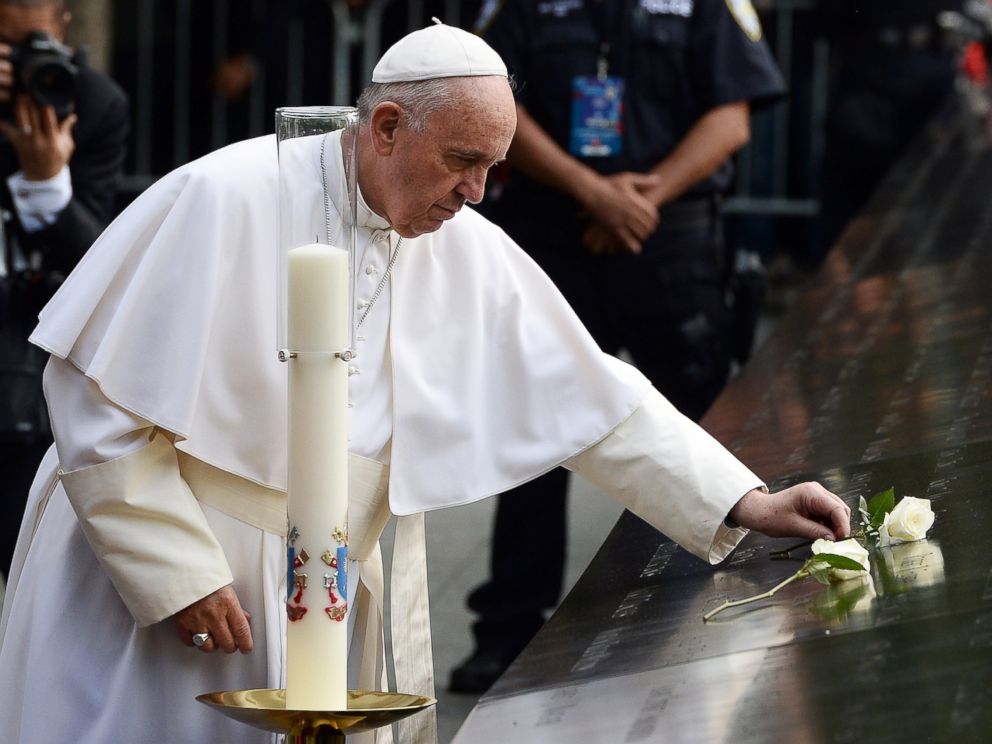 PHOTO:Pope Francis places a white rose on the names of the September 11 victims at the edge of the South Pool of the 9/11 memorial in New York, Sept. 25, 2015. 